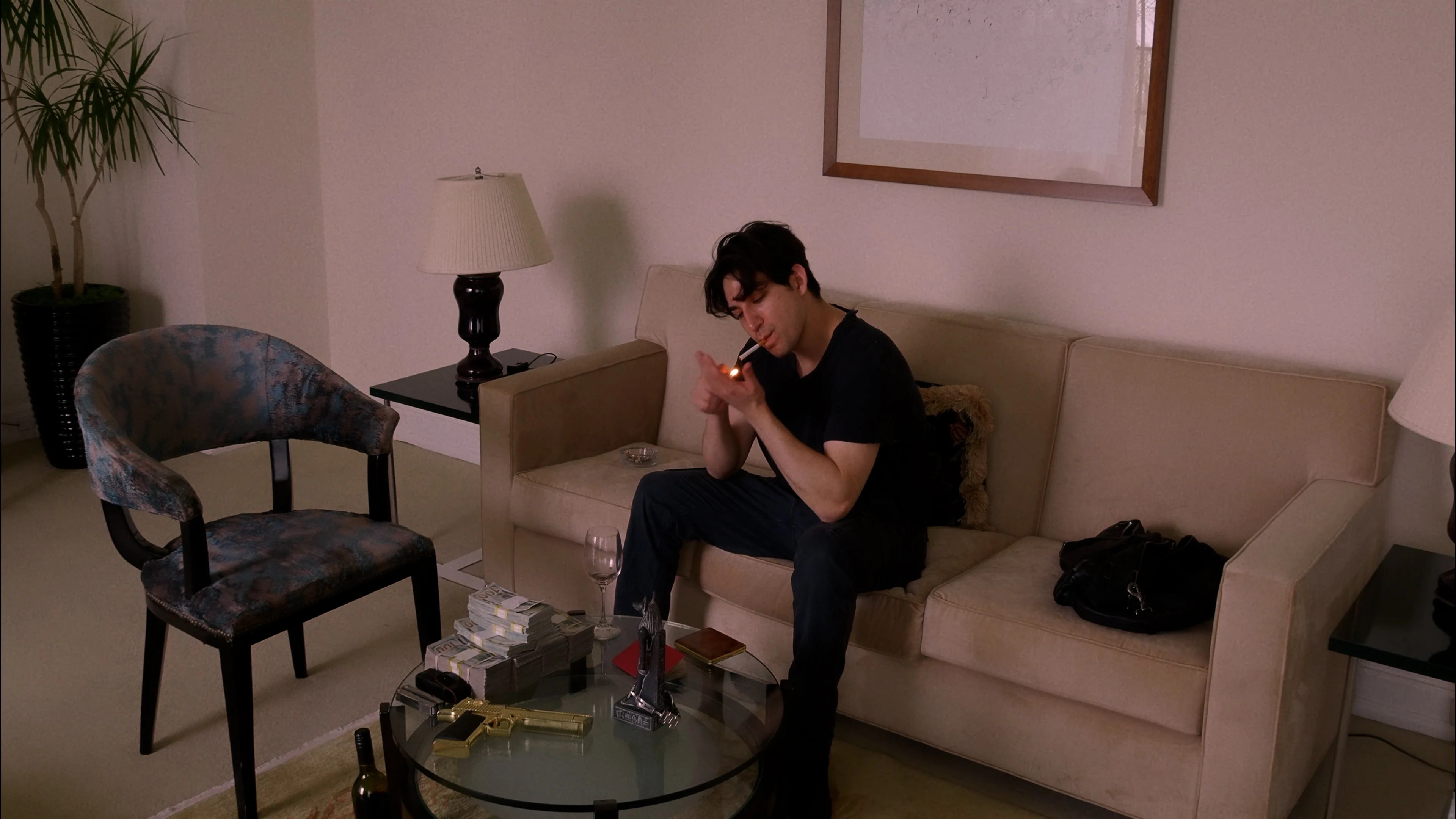 Ian Bloom in King reflected in a mirror wearing a dark trench coat