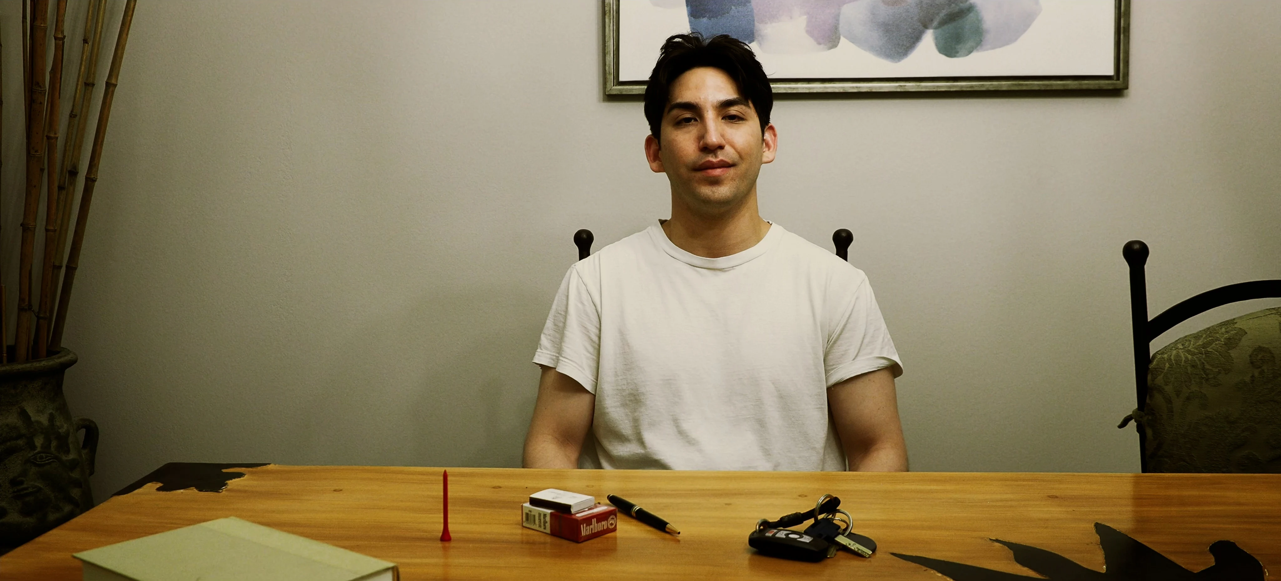Ian Bloom as The Star in Star Vehicle framed in a close portrait inside a dim room
