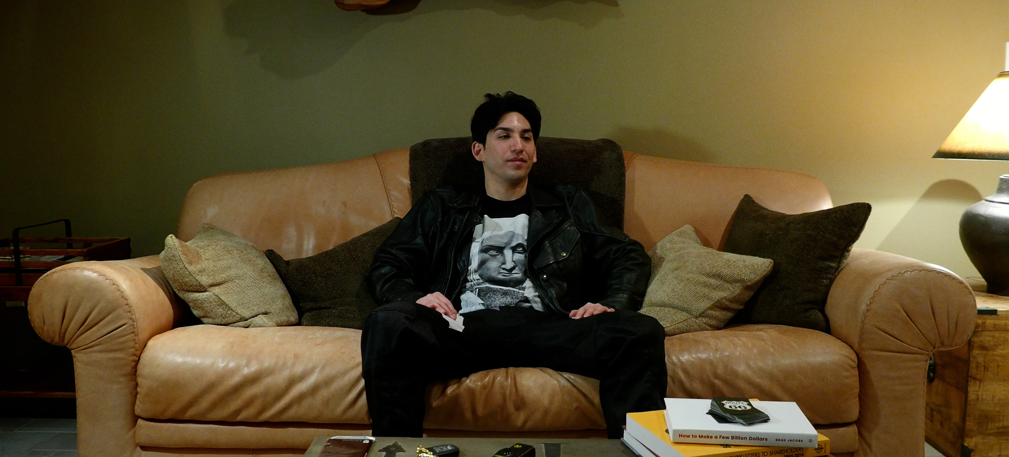 Ian Bloom as The Star in Star Vehicle seated in a dark interior